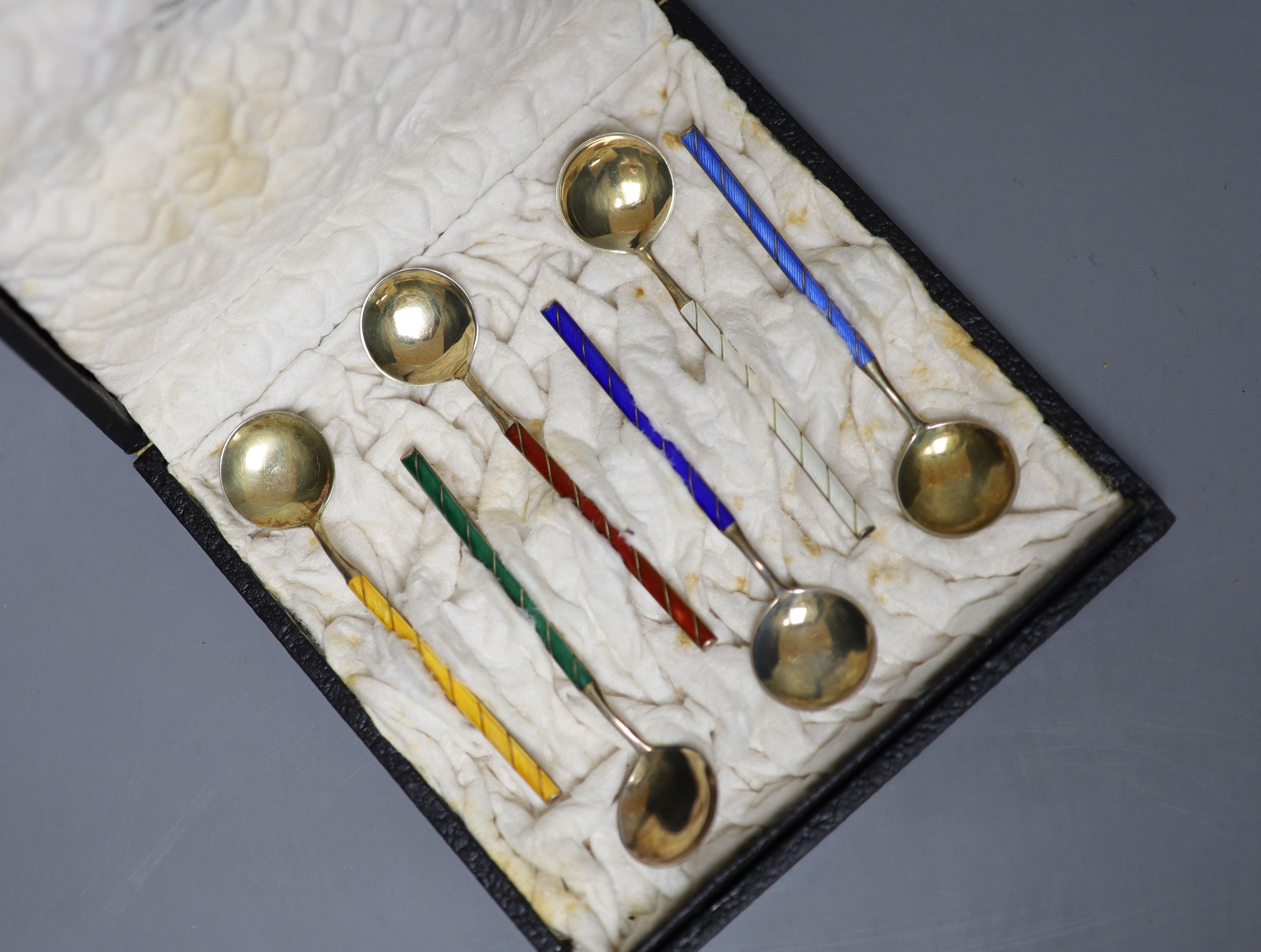 A cased set of six Norwegian gilt white metal and enamel coffee spoons.